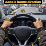 Une femme concentrée au volant de sa voiture en direction sur une route